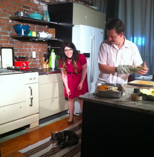 On the set of our third episode, performing the ritual of clearing kitties out of the kitchen.